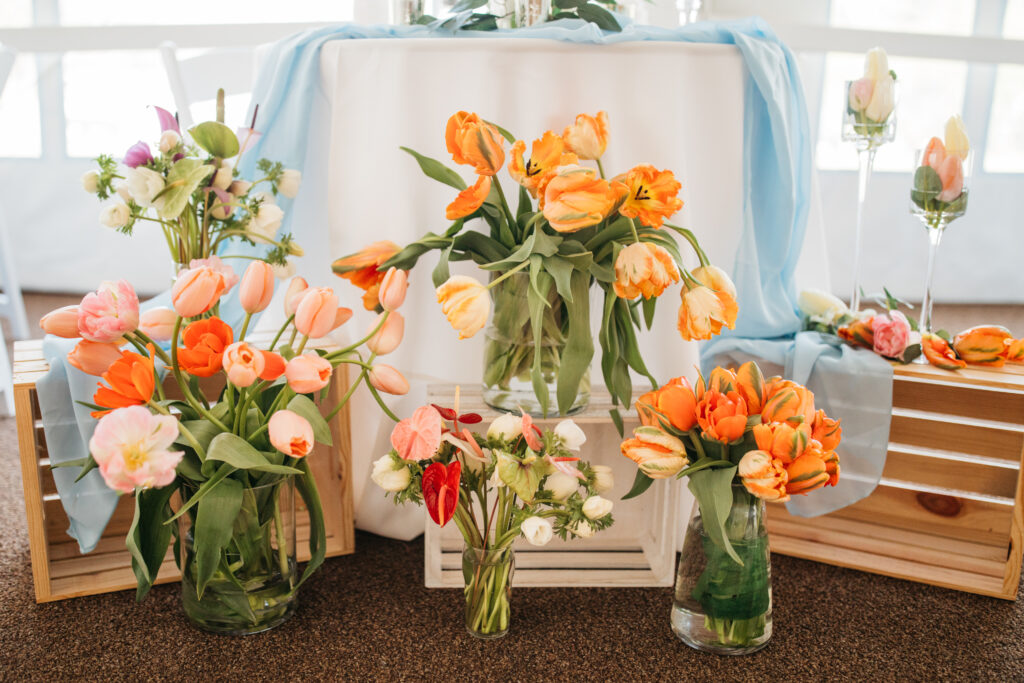 image shows a sweetheart wedding table adorned with flower arrangements