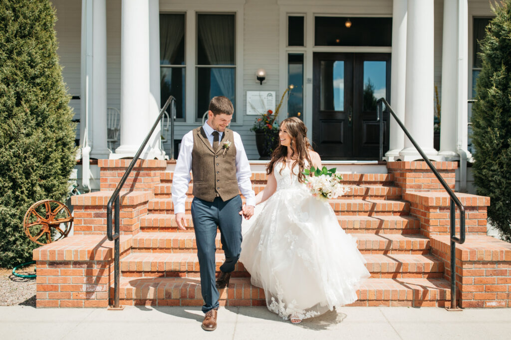 image shows and bride and groom walking down the steps of their wedding venue