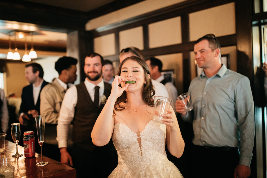 image shows a bride taking a tequila shot
