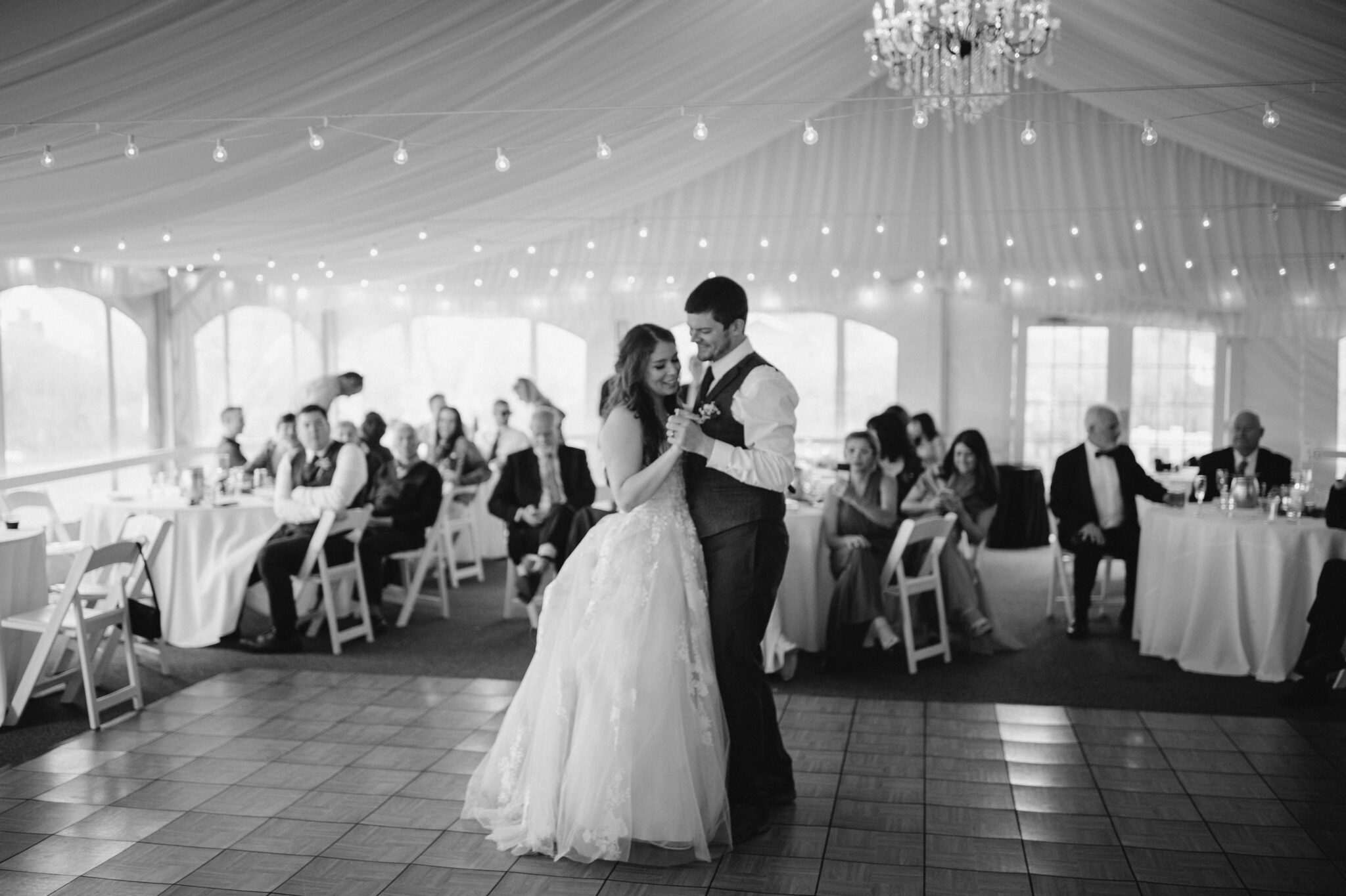 image shows a black and white photo of a bride and groom dancing