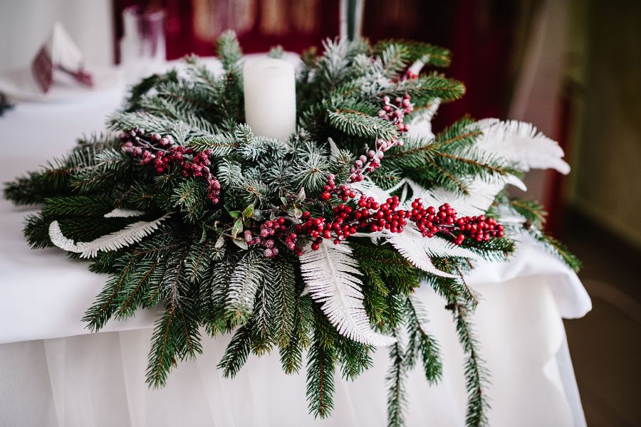 image shows winter greenery and floral table display