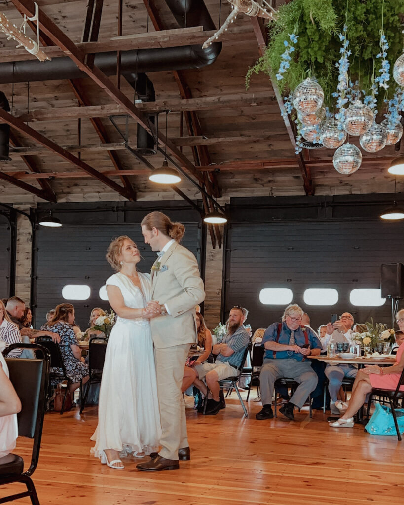 image shows a bride and groom dancing