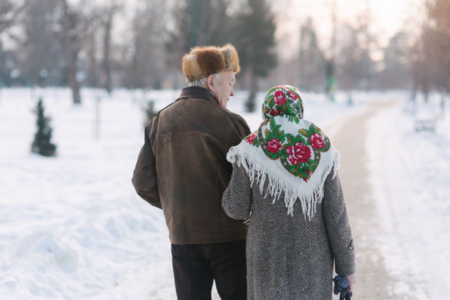 image shows a couple walking together in snow