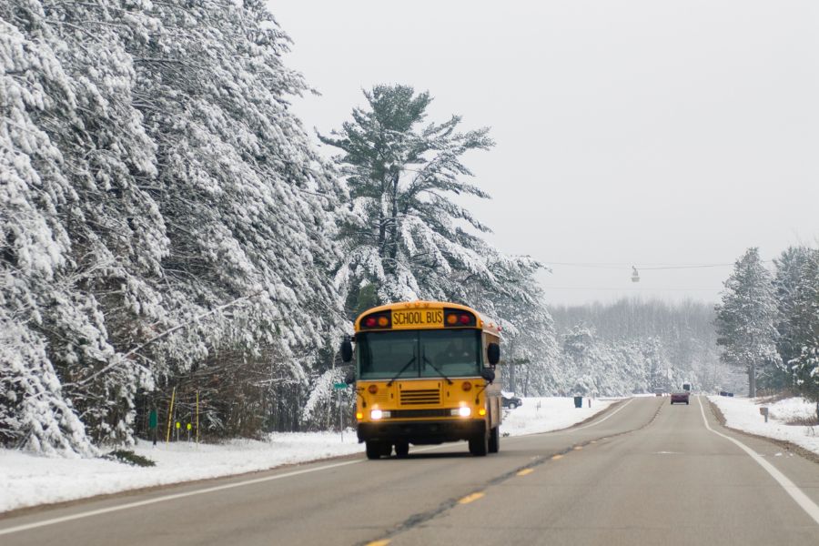 image shows a bus driving on a winter day