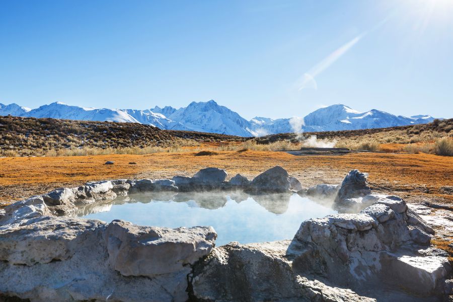 image shows steamy natural hotsprings in the mountains