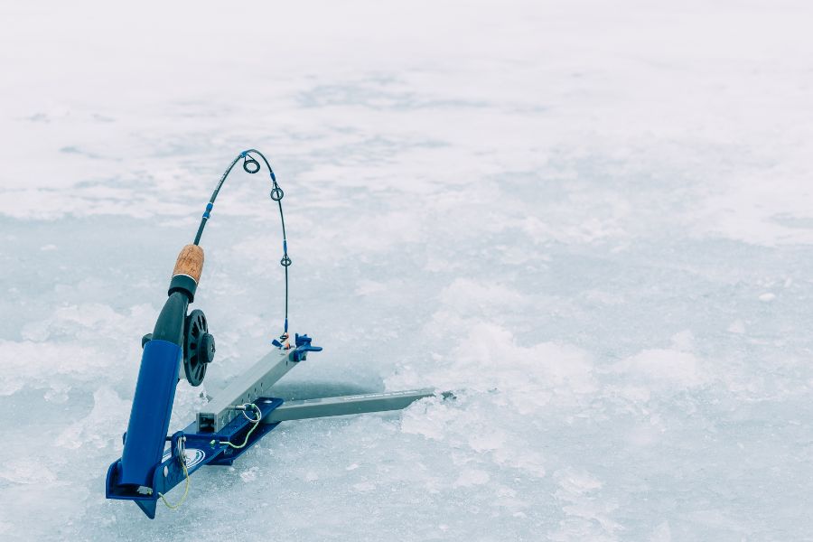 image shows an icefishing rod set up on ice