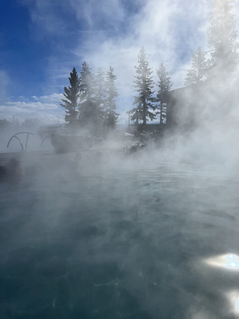 image shows steam coming from an outdoor hotspring