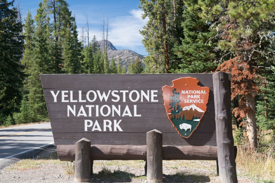 image shows a sign that says yellowstone national park