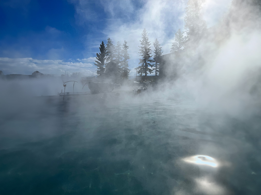 image shows steam from a hot spring pool