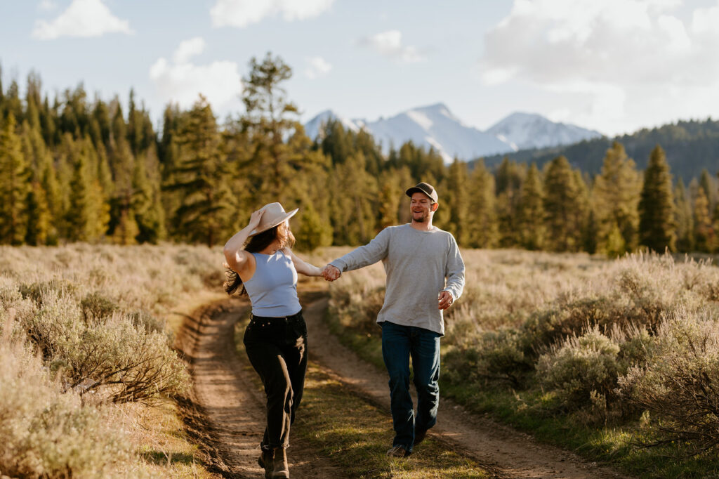 image shows a couple holding hands and running
