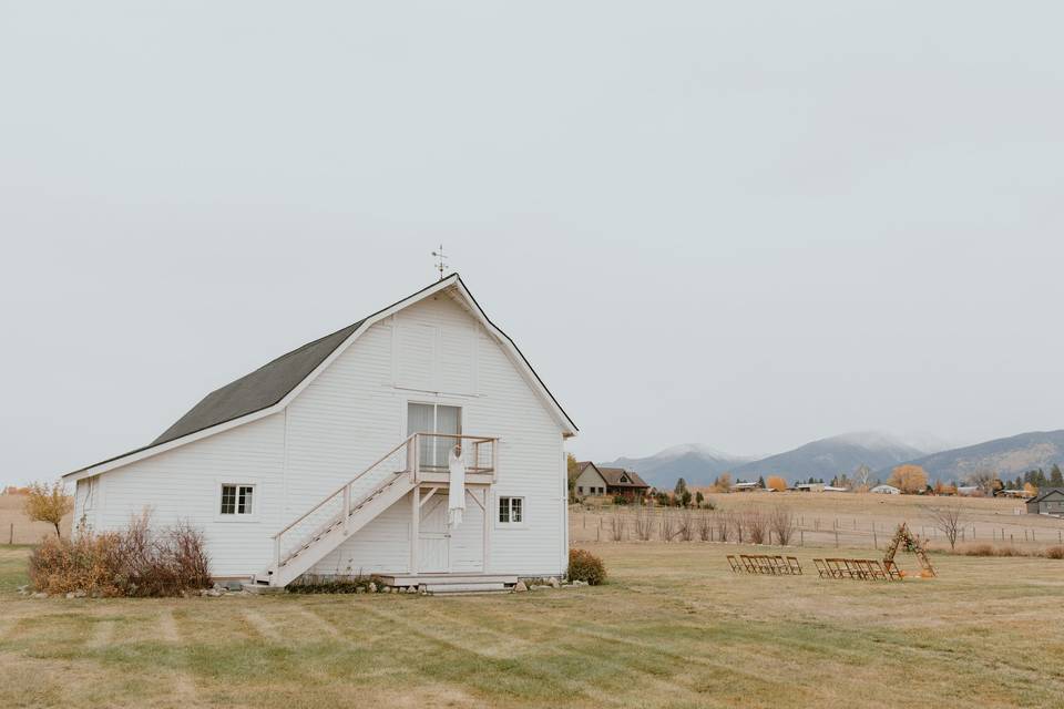 image shows a white wedding barn